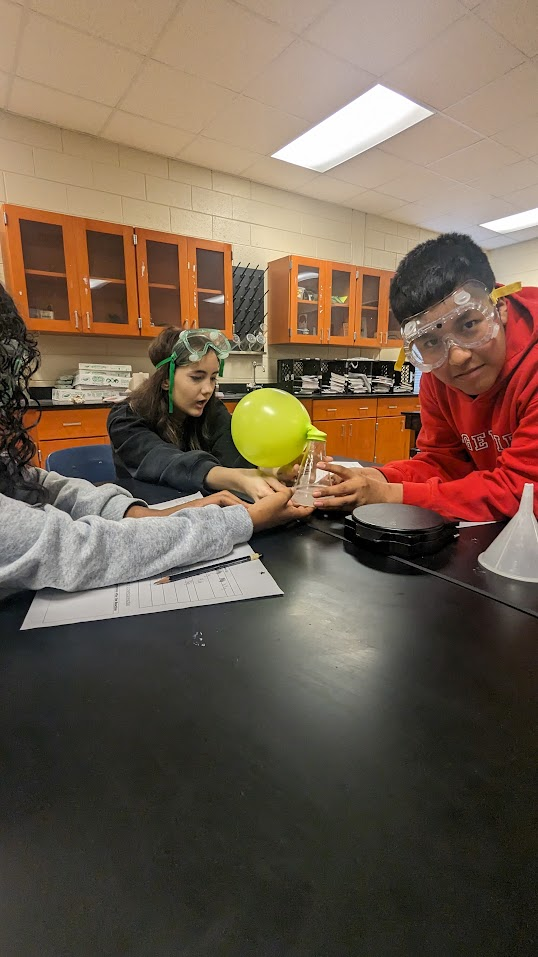 Students conducting an inquiry lab with a balloon