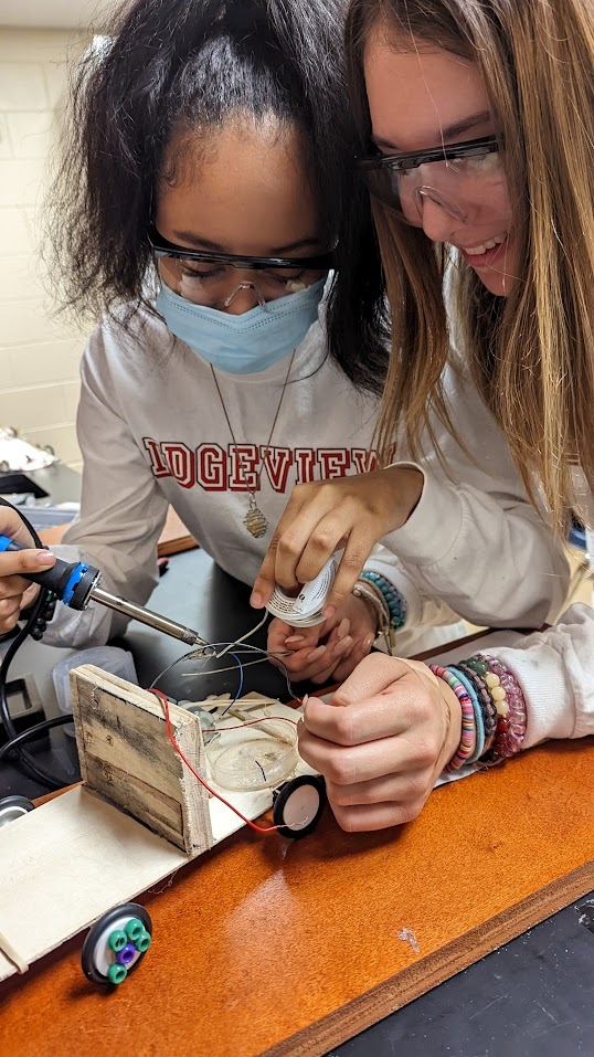 Students building a circuit together